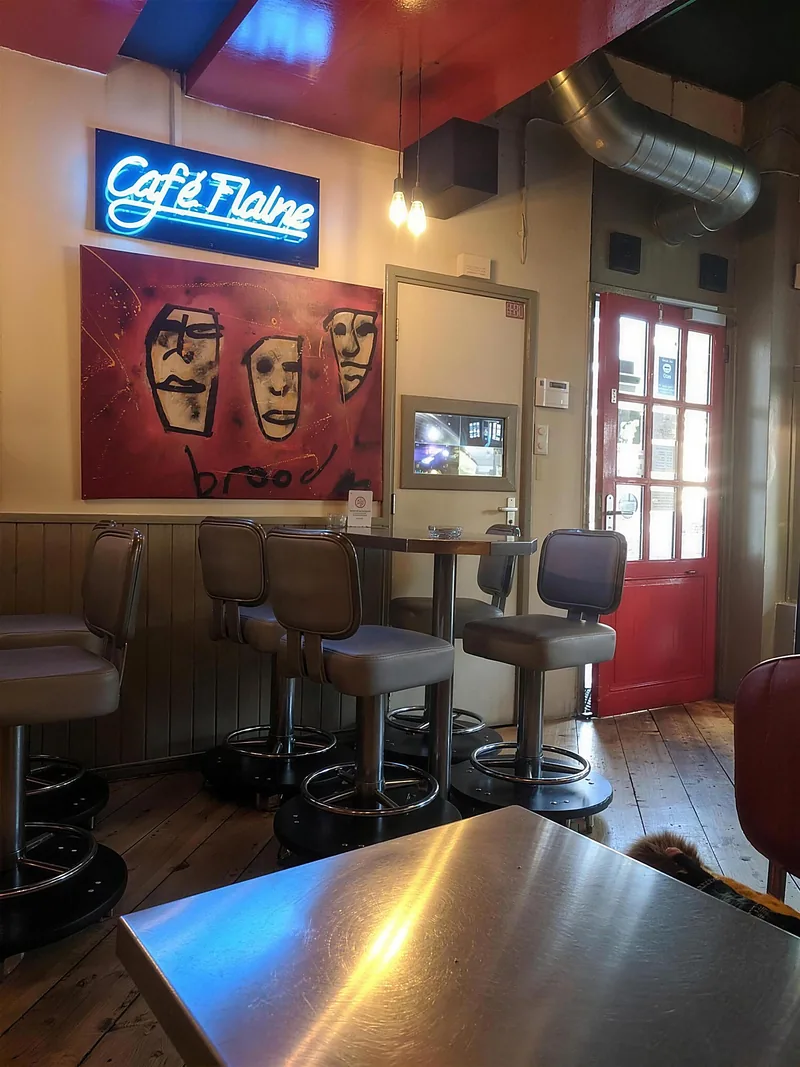 Inside Empire: bar stools, a neon sign and art on the wall